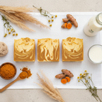 Overhead flat lay of Mabrielle Sinag Turmeric Goat Milk Soap with fresh turmeric, goat milk and botanicals on white linen