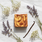 Velvet Mist soap flat lay on white linen with lavender sprigs and vanilla pod