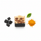 Ember Ash soap overhead flat lay with turmeric and charcoal ingredients